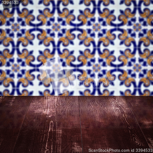 Image of Wood table top and blur vintage ceramic tile pattern wall