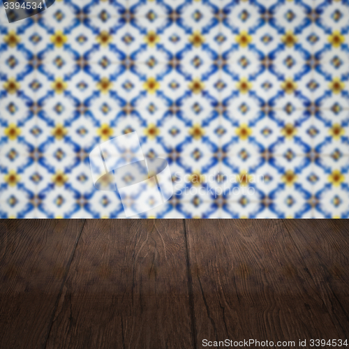 Image of Wood table top and blur vintage ceramic tile pattern wall