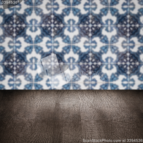 Image of Wood table top and blur vintage ceramic tile pattern wall