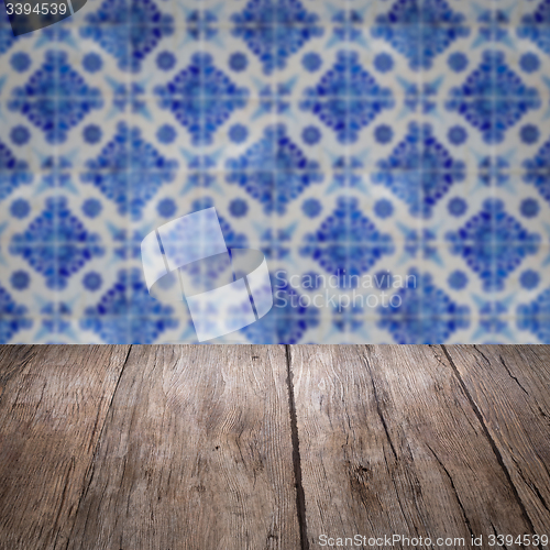 Image of Wood table top and blur vintage ceramic tile pattern wall