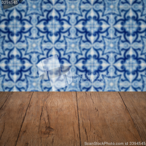 Image of Wood table top and blur vintage ceramic tile pattern wall
