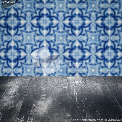 Image of Wood table top and blur vintage ceramic tile pattern wall