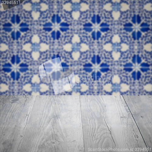 Image of Wood table top and blur vintage ceramic tile pattern wall