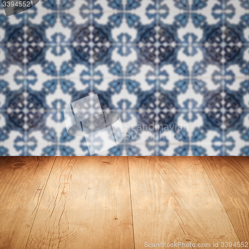 Image of Wood table top and blur vintage ceramic tile pattern wall