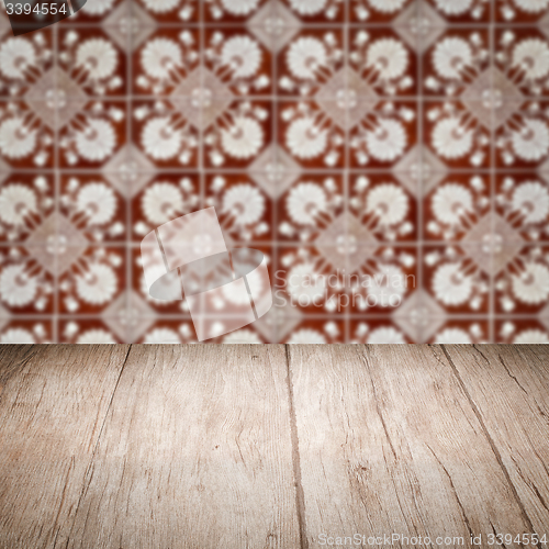 Image of Wood table top and blur vintage ceramic tile pattern wall