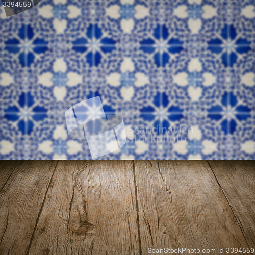 Image of Wood table top and blur vintage ceramic tile pattern wall