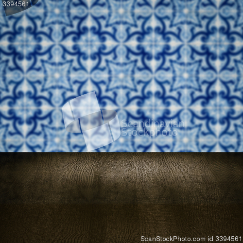 Image of Wood table top and blur vintage ceramic tile pattern wall