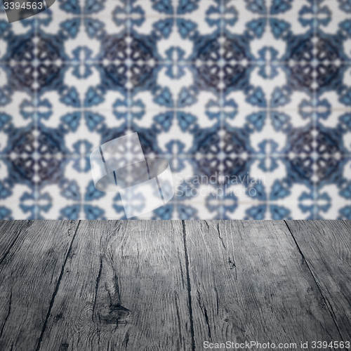 Image of Wood table top and blur vintage ceramic tile pattern wall