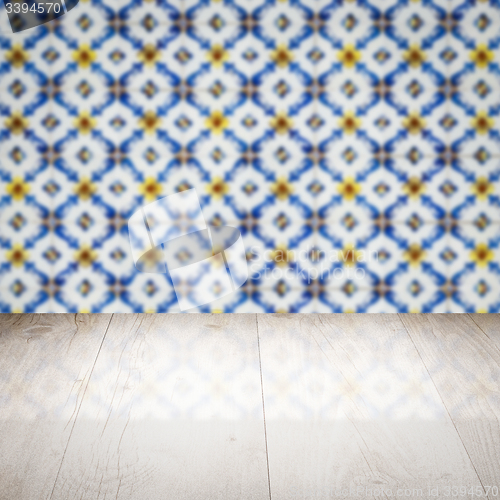 Image of Wood table top and blur vintage ceramic tile pattern wall