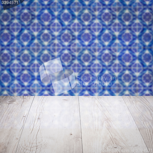 Image of Wood table top and blur vintage ceramic tile pattern wall