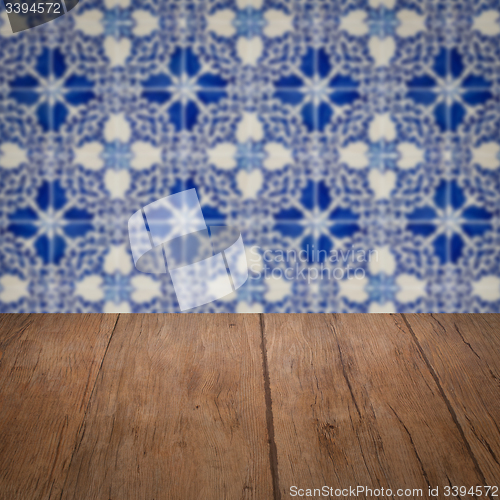 Image of Wood table top and blur vintage ceramic tile pattern wall