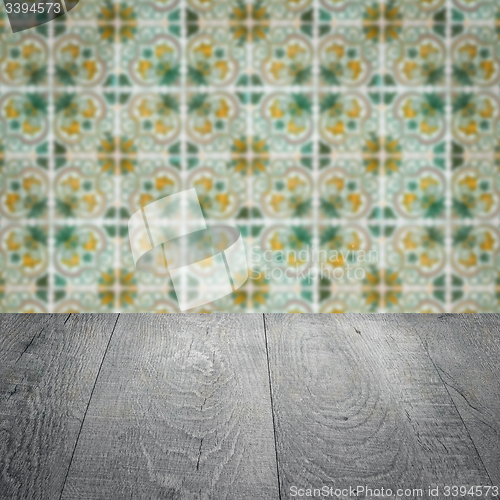 Image of Wood table top and blur vintage ceramic tile pattern wall