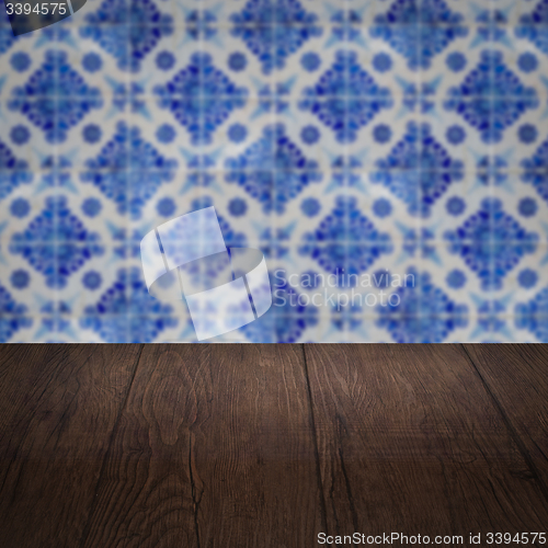 Image of Wood table top and blur vintage ceramic tile pattern wall