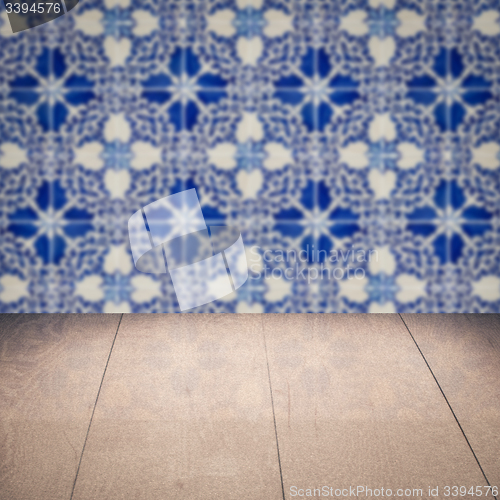 Image of Wood table top and blur vintage ceramic tile pattern wall