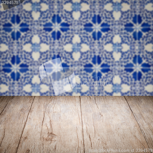 Image of Wood table top and blur vintage ceramic tile pattern wall