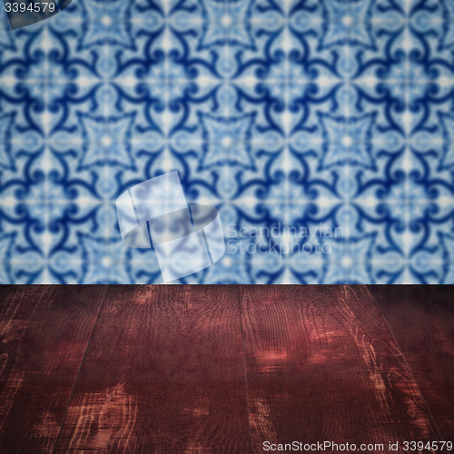 Image of Wood table top and blur vintage ceramic tile pattern wall