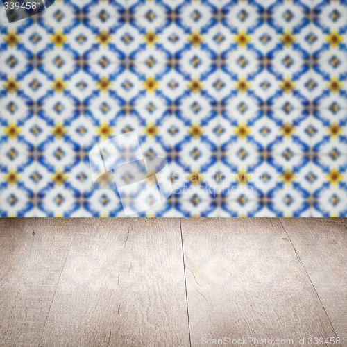 Image of Wood table top and blur vintage ceramic tile pattern wall