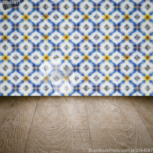 Image of Wood table top and blur vintage ceramic tile pattern wall