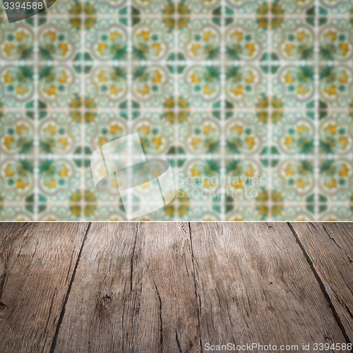 Image of Wood table top and blur vintage ceramic tile pattern wall