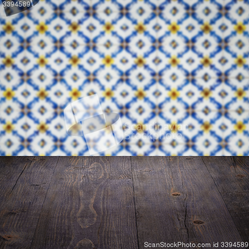 Image of Wood table top and blur vintage ceramic tile pattern wall