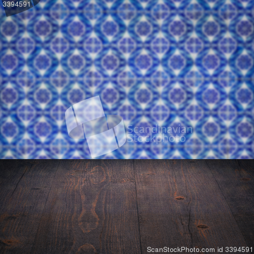 Image of Wood table top and blur vintage ceramic tile pattern wall