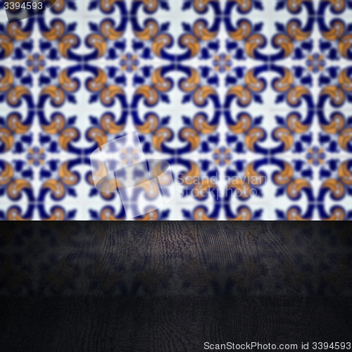 Image of Wood table top and blur vintage ceramic tile pattern wall