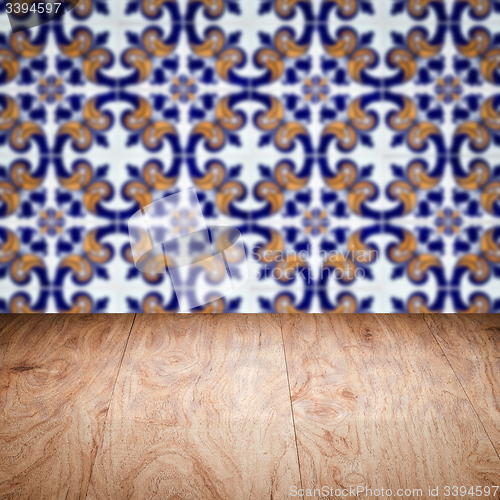 Image of Wood table top and blur vintage ceramic tile pattern wall