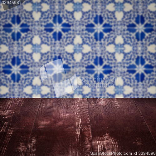 Image of Wood table top and blur vintage ceramic tile pattern wall