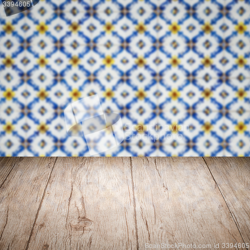Image of Wood table top and blur vintage ceramic tile pattern wall