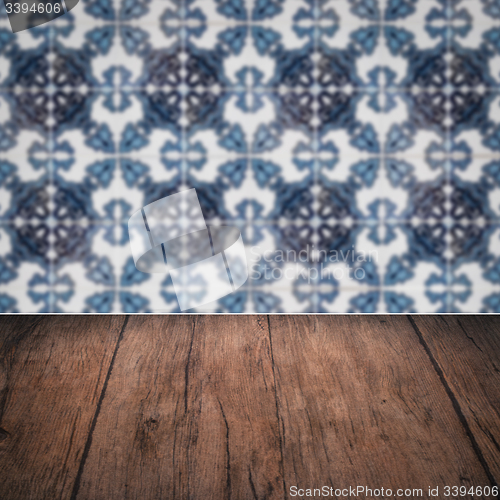 Image of Wood table top and blur vintage ceramic tile pattern wall