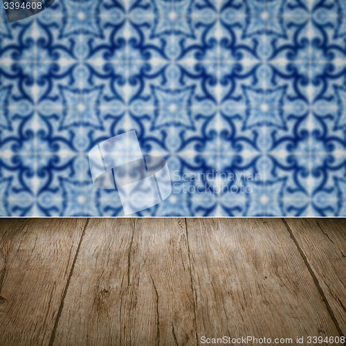 Image of Wood table top and blur vintage ceramic tile pattern wall