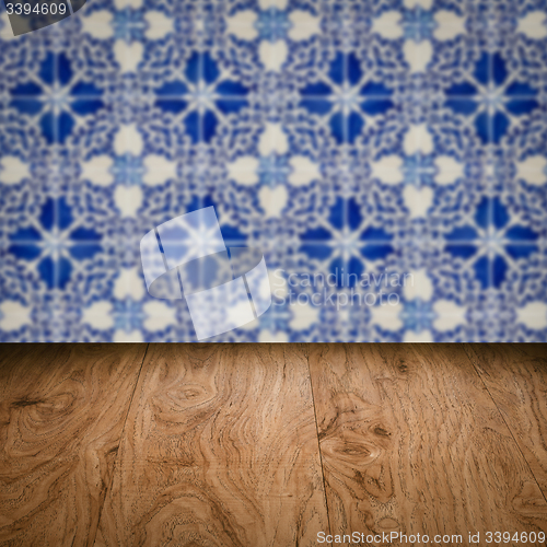 Image of Wood table top and blur vintage ceramic tile pattern wall