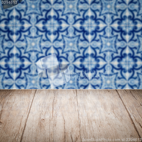 Image of Wood table top and blur vintage ceramic tile pattern wall