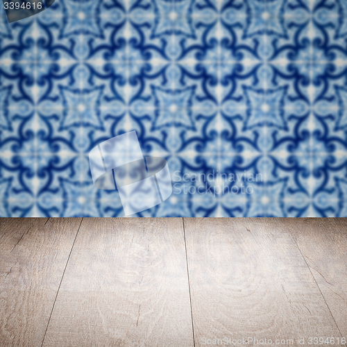Image of Wood table top and blur vintage ceramic tile pattern wall