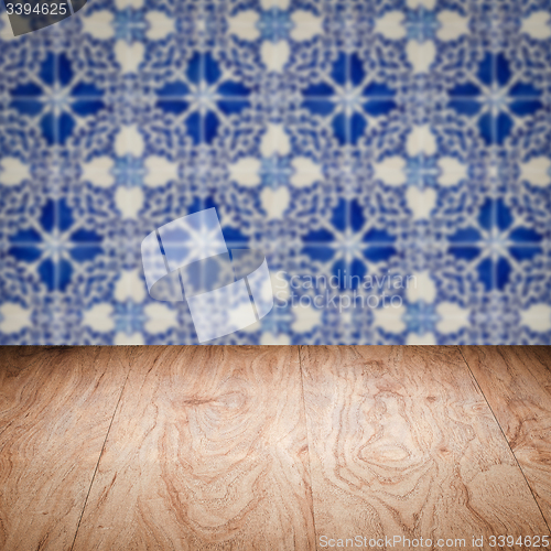 Image of Wood table top and blur vintage ceramic tile pattern wall