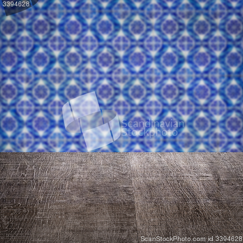 Image of Wood table top and blur vintage ceramic tile pattern wall