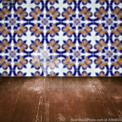 Image of Wood table top and blur vintage ceramic tile pattern wall