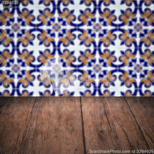 Image of Wood table top and blur vintage ceramic tile pattern wall