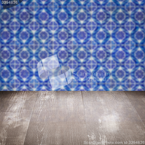 Image of Wood table top and blur vintage ceramic tile pattern wall