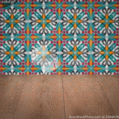 Image of Wood table top and blur vintage ceramic tile pattern wall
