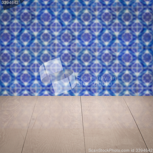 Image of Wood table top and blur vintage ceramic tile pattern wall