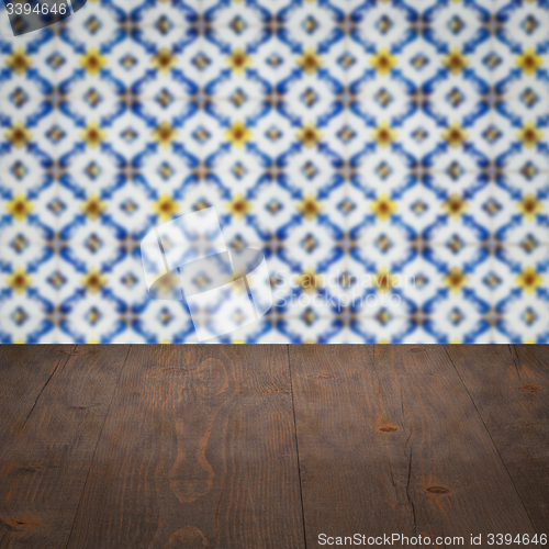 Image of Wood table top and blur vintage ceramic tile pattern wall