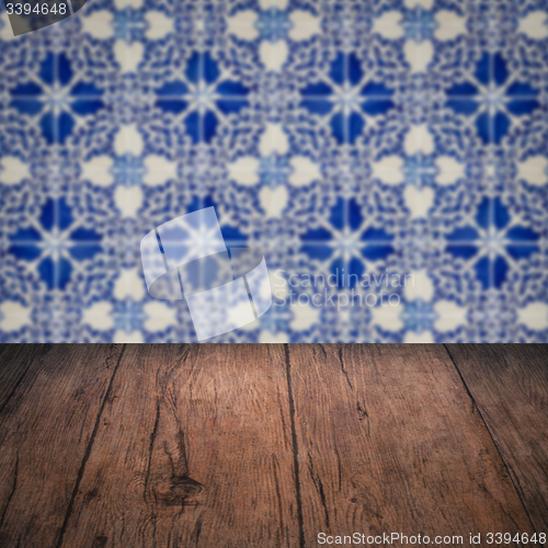 Image of Wood table top and blur vintage ceramic tile pattern wall