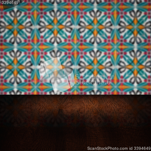 Image of Wood table top and blur vintage ceramic tile pattern wall