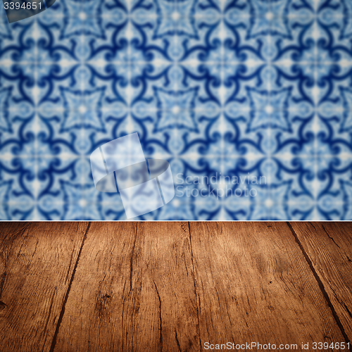 Image of Wood table top and blur vintage ceramic tile pattern wall