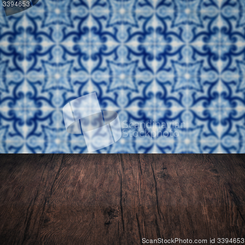 Image of Wood table top and blur vintage ceramic tile pattern wall