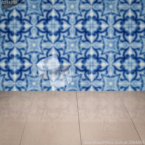 Image of Wood table top and blur vintage ceramic tile pattern wall