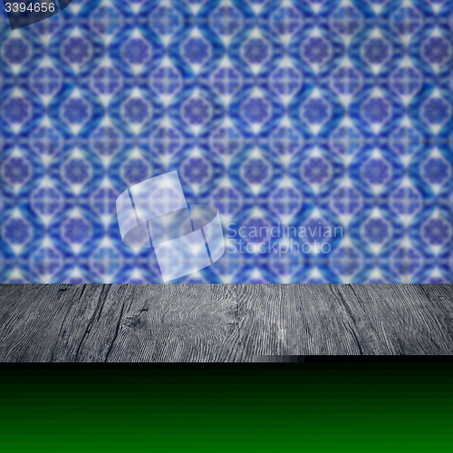 Image of Wood table top and blur vintage ceramic tile pattern wall