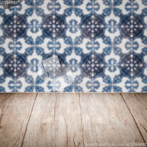 Image of Wood table top and blur vintage ceramic tile pattern wall