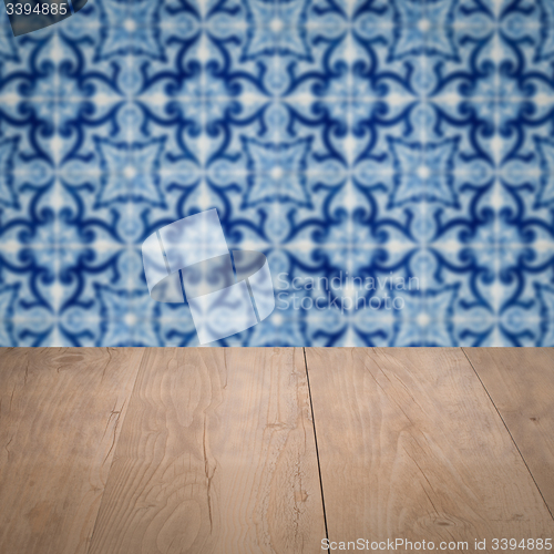Image of Wood table top and blur vintage ceramic tile pattern wall